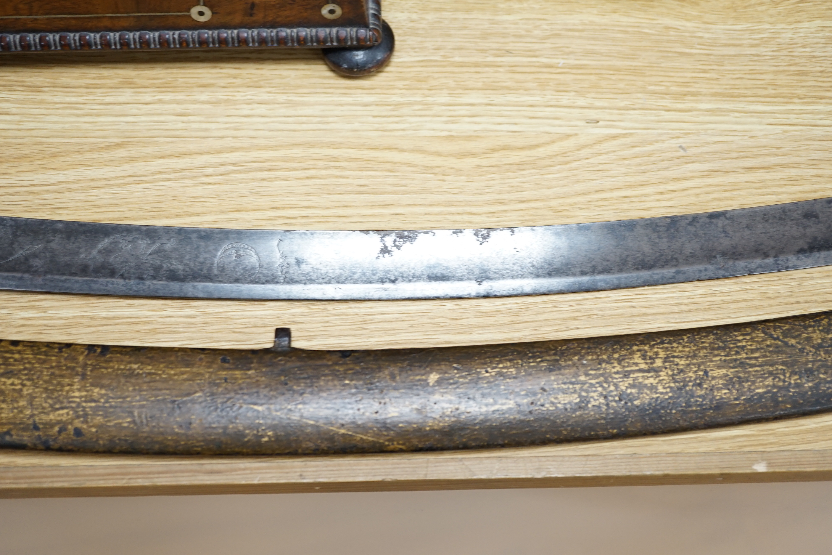 An 18th century English cavalry sword with eastern related engraving to blade